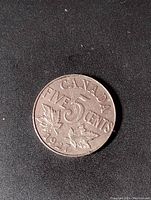 Obverse side showing the denomination and maple leaves with date 1927.