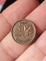 Reverse side of the 1939 Canadian 1 cent coin displaying two maple leaves, denomination, year and country name.