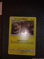 Front of Detective Pikachu Pokemon card showing holographic image and stats.
