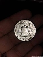 Reverse side of the same 1953 Franklin half dollar showing the Liberty Bell and inscriptions UNITED STATES OF AMERICA, E PLURIBUS UNUM, HALF DOLLAR.