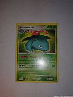 Photo shows Venusaur Level 51 Pokémon card with visible artwork, stats, and move descriptions