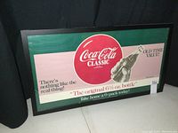 Front view of the framed Coca-Cola Classic poster showing full artwork and text.