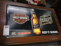 Full view of the metal sign showing Harley Davidson and Miller Genuine Draft logos along with beer bottle image