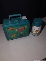 Photo of greenish teal Lion King Hakuna Matata plastic lunch pail with matching thermos.