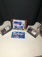 Four Pepsi die cast trucks displayed with the limited edition gift bank and three smaller trucks in packaging.