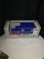 Photo of the boxed vintage Pepsi-Cola steel truck, showing full packaging and truck inside.