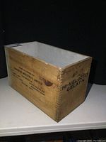 Side view of vintage wooden crate showing Canadian Industries Limited branding and product markings