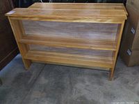 Front view of the solid maple bookshelf showing the top surface, open shelf, and back panel.