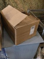 Closed cardboard shipping box containing the lot of hand sanitizers.