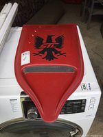Top view of the red resin hood scoop showing the black eagle logo with 'STL' text and mesh intake area.