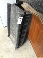 Closed view of black resin folding pet ramp showing textured side and side profile.