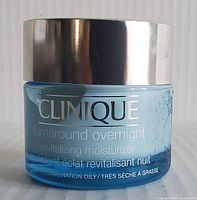 Front view of Clinique moisturizer jar showing label with product name and skin type information.
