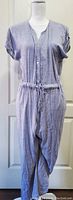 Front view of lightweight Jones New York ladies jumpsuit size Medium, showing button closure, drawstring waist, cuffed short sleeves.