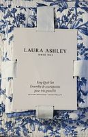 Photo of Laura Ashley label on the king quilt set packaging showing brand and cotton prewashed fabric details.