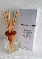 Omnibus fragrance diffuser bottle with wooden lid and diffuser sticks inserted, showing packaging label with scent Provence, product number, and volume 30ml.