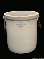 Front view of the white Robinson Ransbottom stoneware crock showing the blue crown with number 6 marking