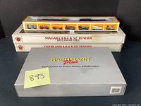 Yellow-trimmed Bachmann HO window box with passenger cars visible inside