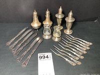 All 22 items laid out showing butter spreaders, nut picks, and pairs of salt and pepper shakers.