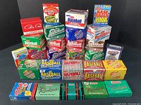 Overview of 27 mixed baseball card boxes on black background