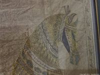 Close-up of the needlepoint horse showing detailed stitching and color fading.