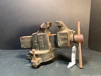 Front left angle view of the Simplex 4 inch bench vice grip showing the steel jaws and handle mechanism with noticeable rust and wear.