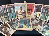 Collection of 1971 Sporting News magazines with baseball players on the covers laid out in a pile and some standing upright.