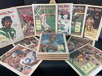 Collection of more than 20 issues of The Sporting News with sports athlete covers from 1972 spread out for display