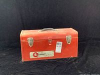 Closed red Omar metal toolbox with handle and clasp lock