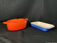 flame orange oval Dutch oven and Marseille blue rectangular dish side by side