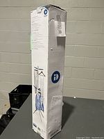 Box of iDesign two-tier clothes drying rack shows product image and dimensions.