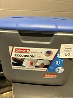 Front and top view of Coleman Excursion cooler with label describing capacity and features.