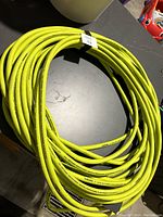 Coiled yellow Husky air hose laid flat showing length and condition.