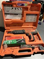 Ramset tool, two boxes of loads, cleaning brush in orange case
