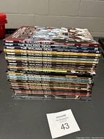Stack of Walking Dead comic books showing spines numbered from 1 to 31 with various cover art.