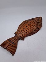 Front view of carved halibut showing overall design and formline patterns