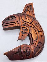 Front view showing carved wooden whale