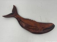 Top view showing full whale sculpture with carved indigenous motifs and smooth finish.