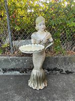 Front view of the vintage lady figurine holding a scalloped tray, showing detailed gown and hair styling