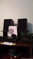 LG Blu-Ray player with remote, manual and power adapter with a pair of Centrios 15" tabletop speakers on stands