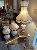 Three vintage electric parlor lamps on wooden table in living room setting
