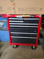 Front of red Sears/Craftsman 9-drawer rolling tool chest on wheels