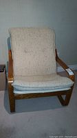Front view of IKEA bentwood chair with cream upholstered cushions and wooden frame.