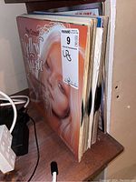 Side view of a stack of vinyl LP records showing Ray Conniff Yellow Music album prominently on top