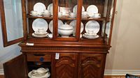 China cabinet closed view showing arrangement of plates, bowls, cups and serving pieces