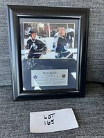 Framed tribute plaque with Ron Ellis in Toronto Maple Leafs uniform, silver plaque with career details, and facsimile signature.