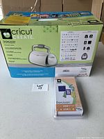 Boxed Cricut Create sign maker with product details and included items printed on the packaging.