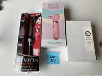 Photo shows three hair styling and care products: Revlon Perfect Heat Ceramic Styling Brush in packaging, Too Cute! pink professional blow dryer in box, and white box of du-luscious 3 piece hair care kit.