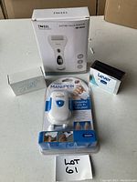 Lot items displayed with JWEEL electric callus remover box, Esplée Mani Pedi device in packaging, and two soap bars from Lever and Zest.