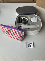 Neck toner device with carrying case and a zippered cosmetic bag beside it