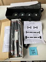 Full view of all workout set components including weights, bars, instructions, and carrying bag